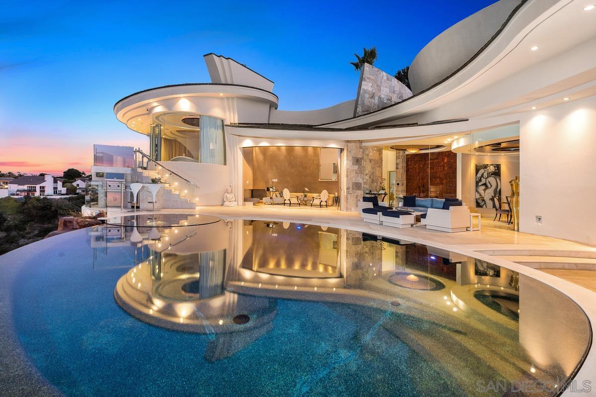 7455 Hillside Drive La Jolla, CA 92037 - Photo 32 of 33 a view of a swimming pool with a table and chairs