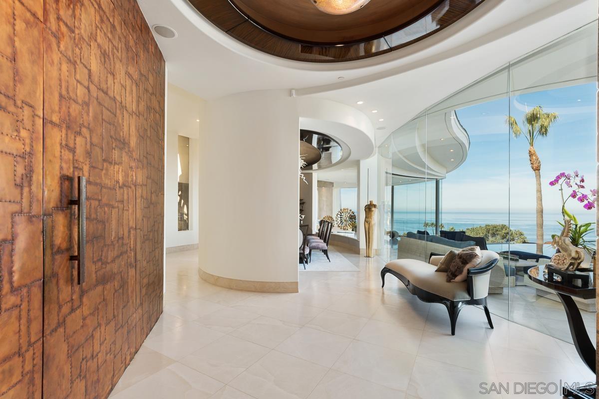 7455 Hillside Drive La Jolla, CA 92037 - Photo 7 of 33 a living room with furniture and a chandelier
