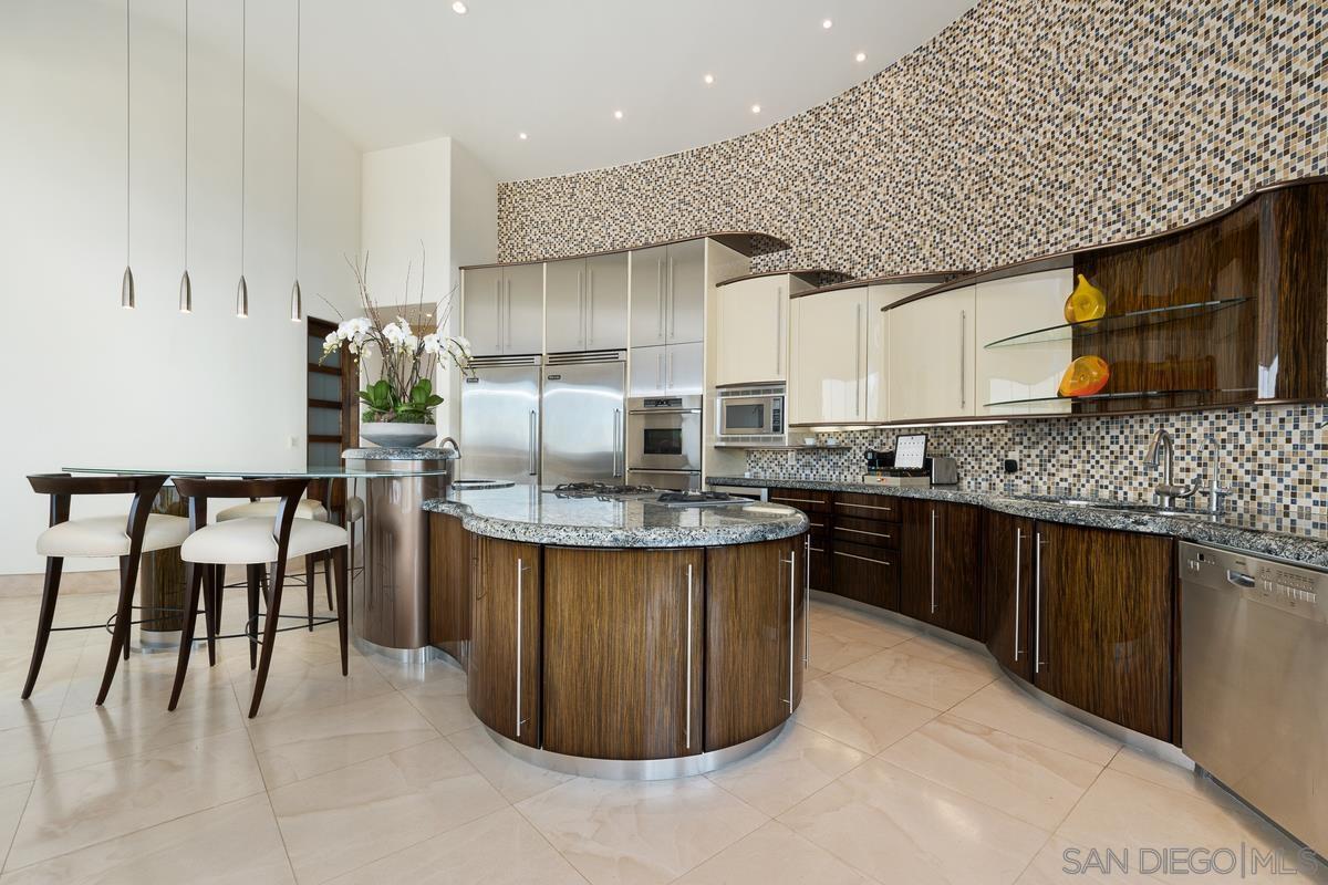 7455 Hillside Drive La Jolla, CA 92037 - Photo 9 of 33 a kitchen with granite countertop a sink and cabinets