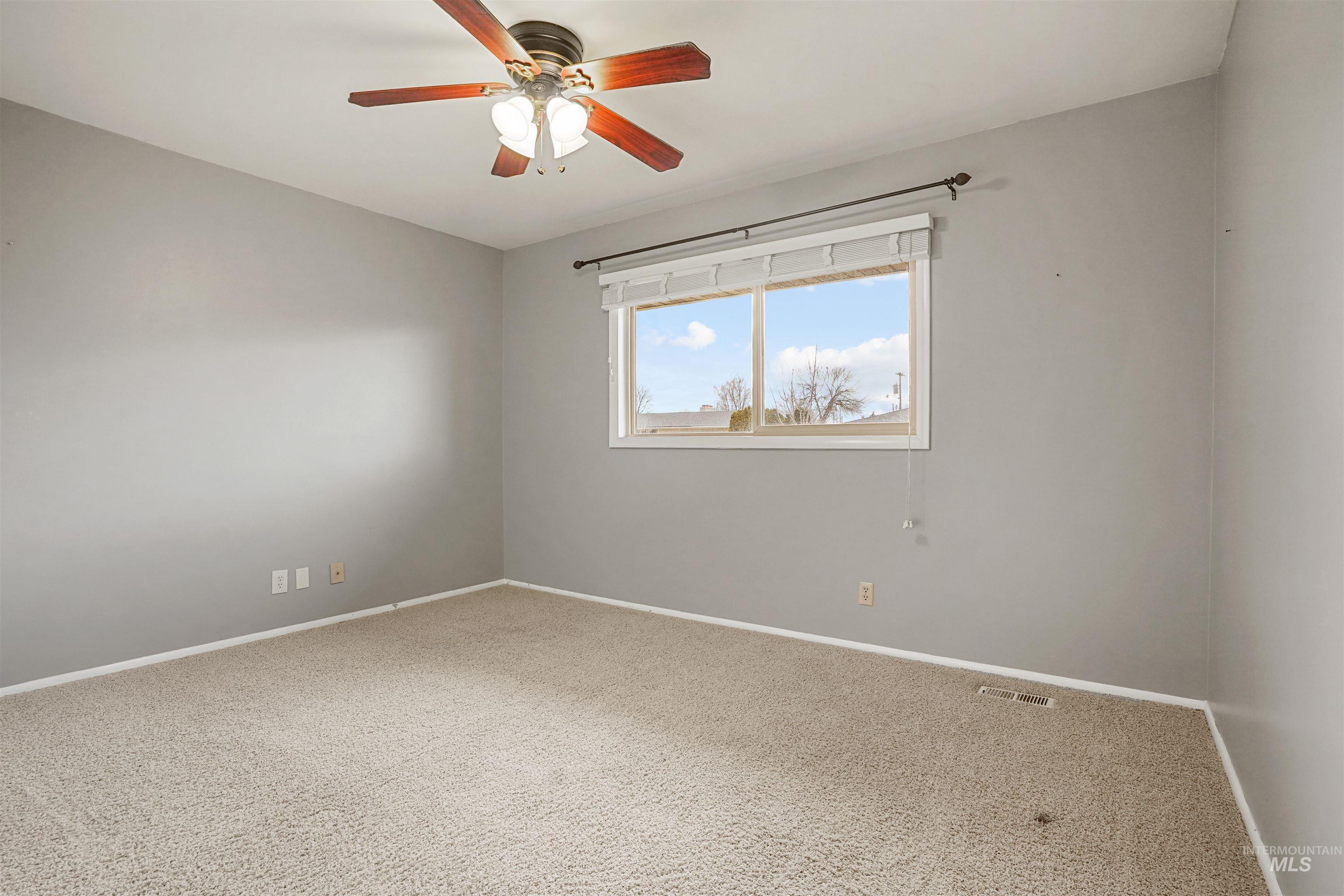 206 Pleasant Way Rupert, ID 83350 - Photo 14 of 33 Unfurnished room with light carpet and ceiling fan
