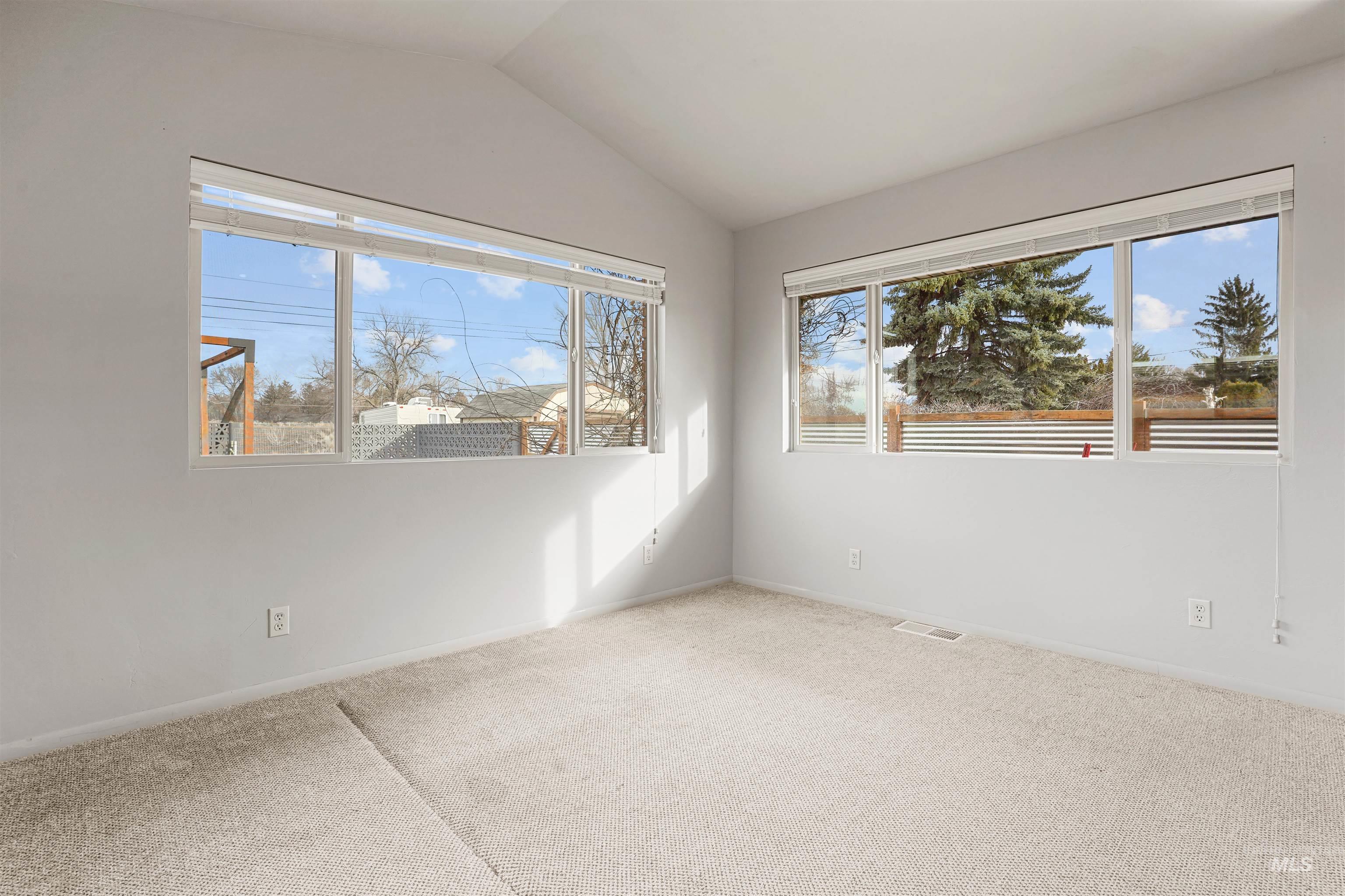 206 Pleasant Way Rupert, ID 83350 - Photo 17 of 33 Carpeted empty room featuring vaulted ceiling and baseboards