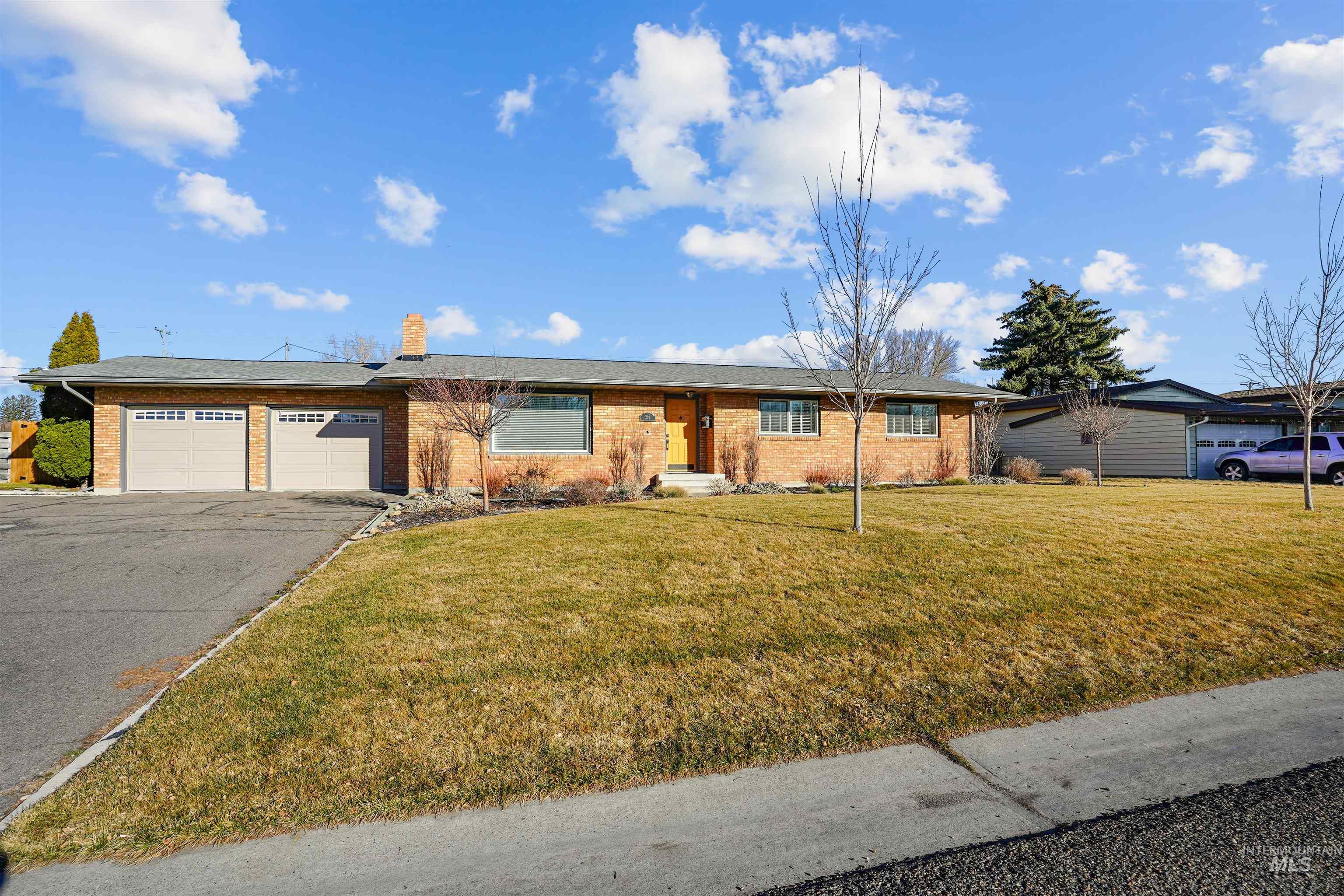 206 Pleasant Way Rupert, ID 83350 - Photo 2 of 33 Single story home featuring brick siding, a front yard, a garage, a chimney, and driveway