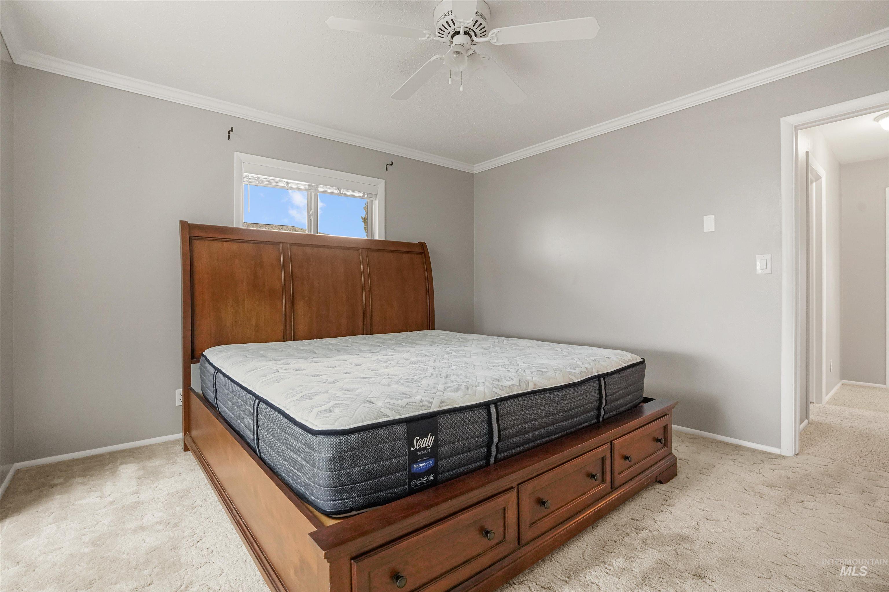 206 Pleasant Way Rupert, ID 83350 - Photo 21 of 33 Bedroom featuring light colored carpet, crown molding, and a ceiling fan