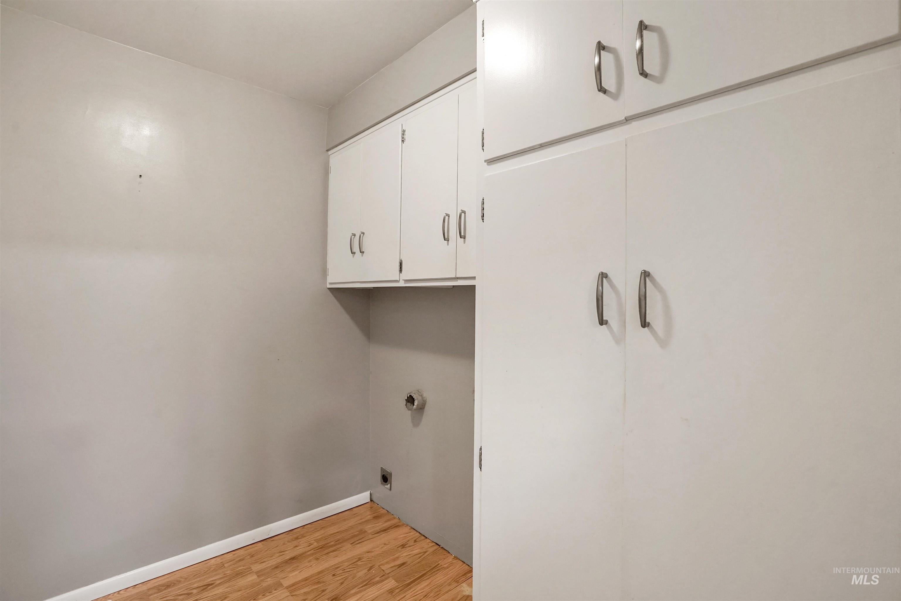 206 Pleasant Way Rupert, ID 83350 - Photo 26 of 33 Laundry area with light wood finished floors, cabinet space, and electric dryer hookup