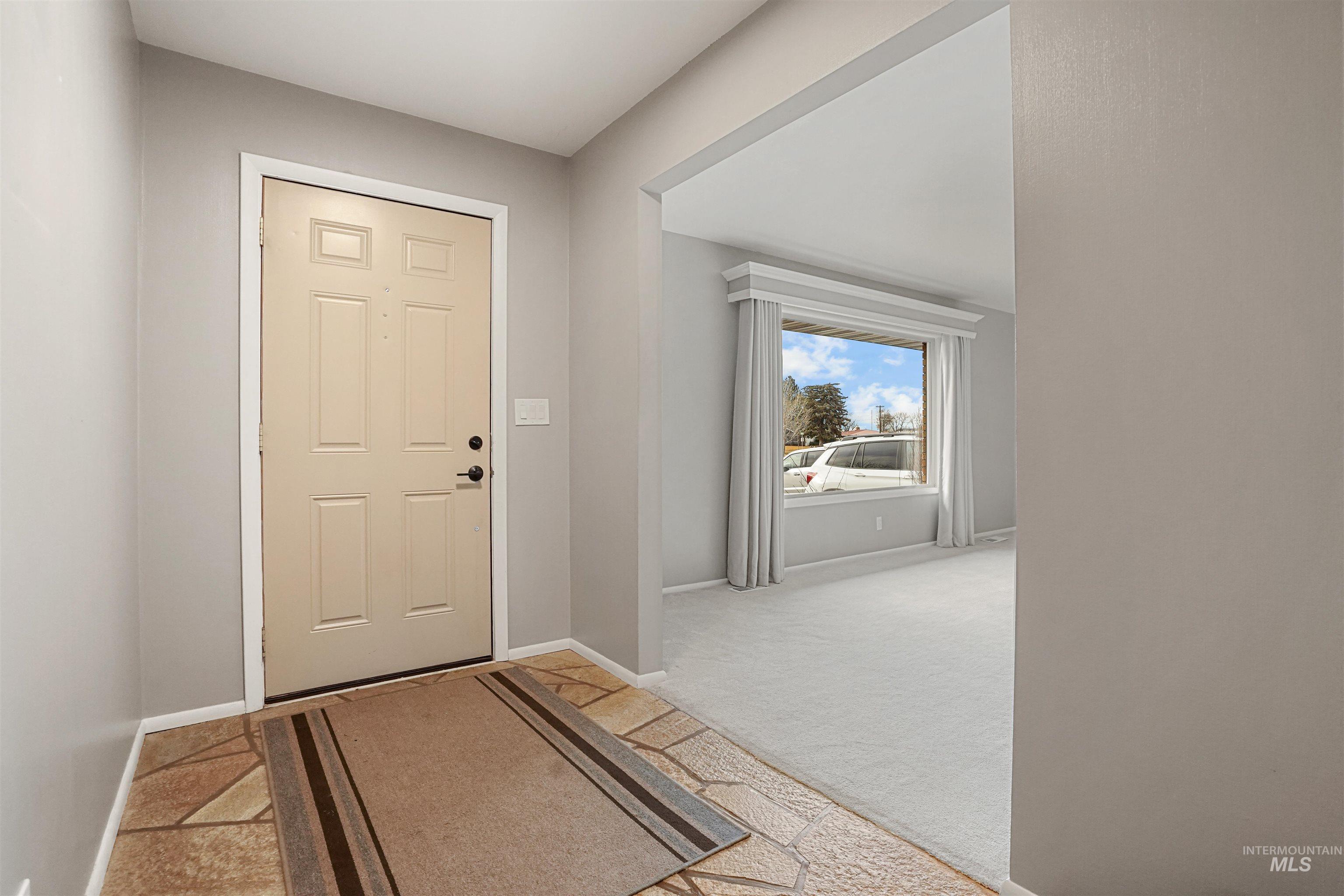 206 Pleasant Way Rupert, ID 83350 - Photo 3 of 33 Entrance foyer with light colored carpet and baseboards