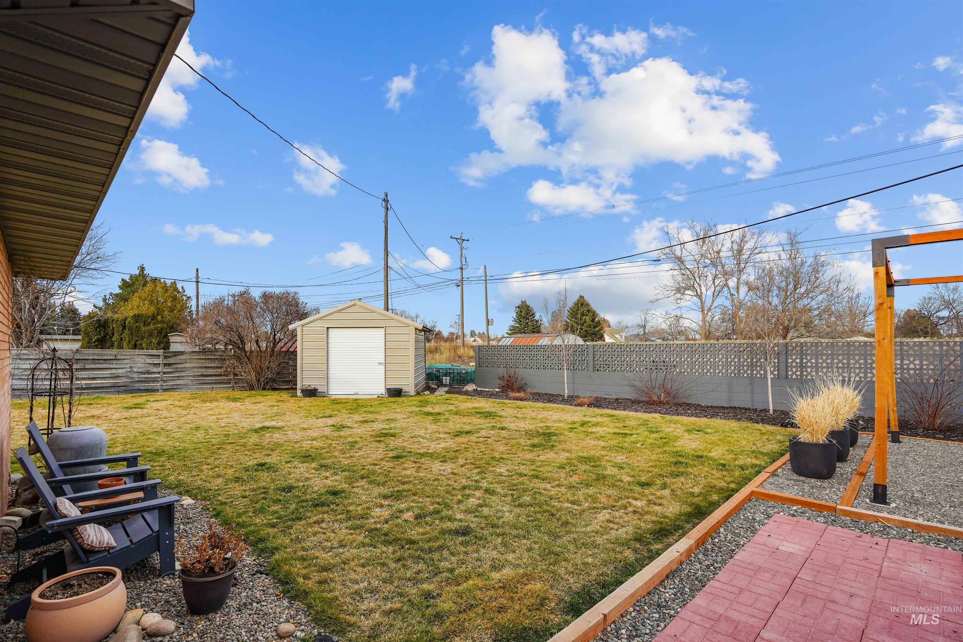 206 Pleasant Way Rupert, ID 83350 - Photo 31 of 33 Fenced backyard with a storage unit and a patio area