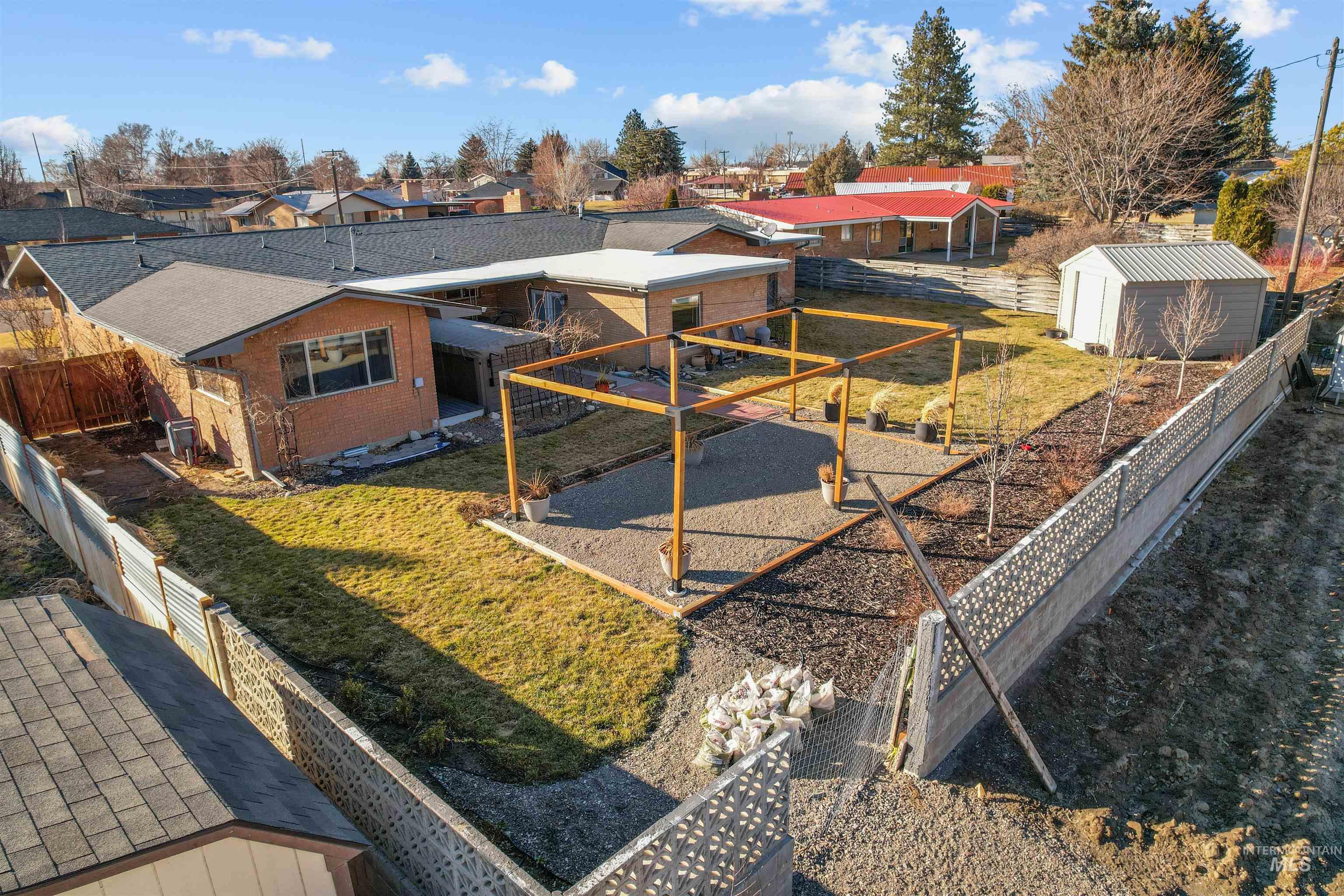 206 Pleasant Way Rupert, ID 83350 - Photo 32 of 33 Fenced backyard featuring a residential view, a shed, and a patio