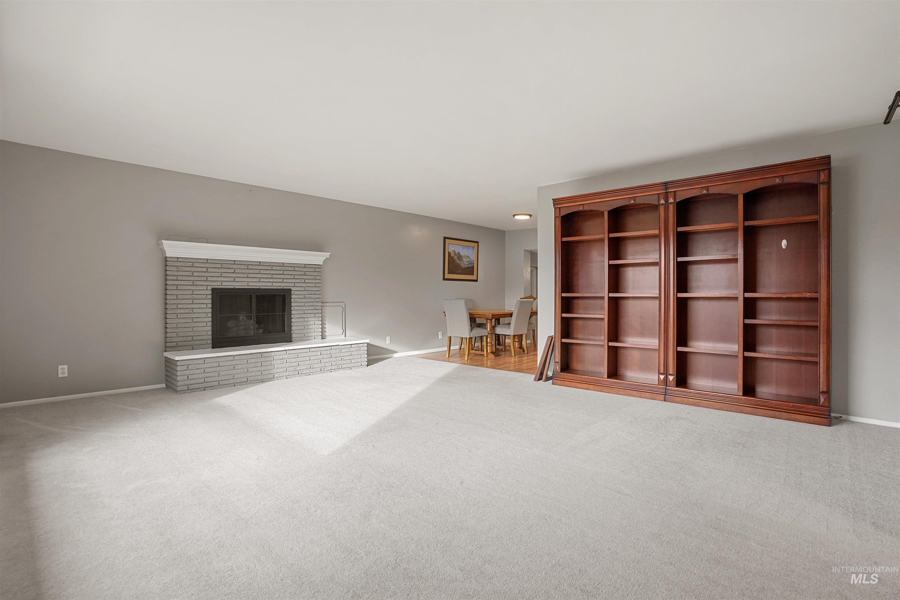 206 Pleasant Way Rupert, ID 83350 - Photo 4 of 33 Unfurnished living room with carpet floors and a brick fireplace