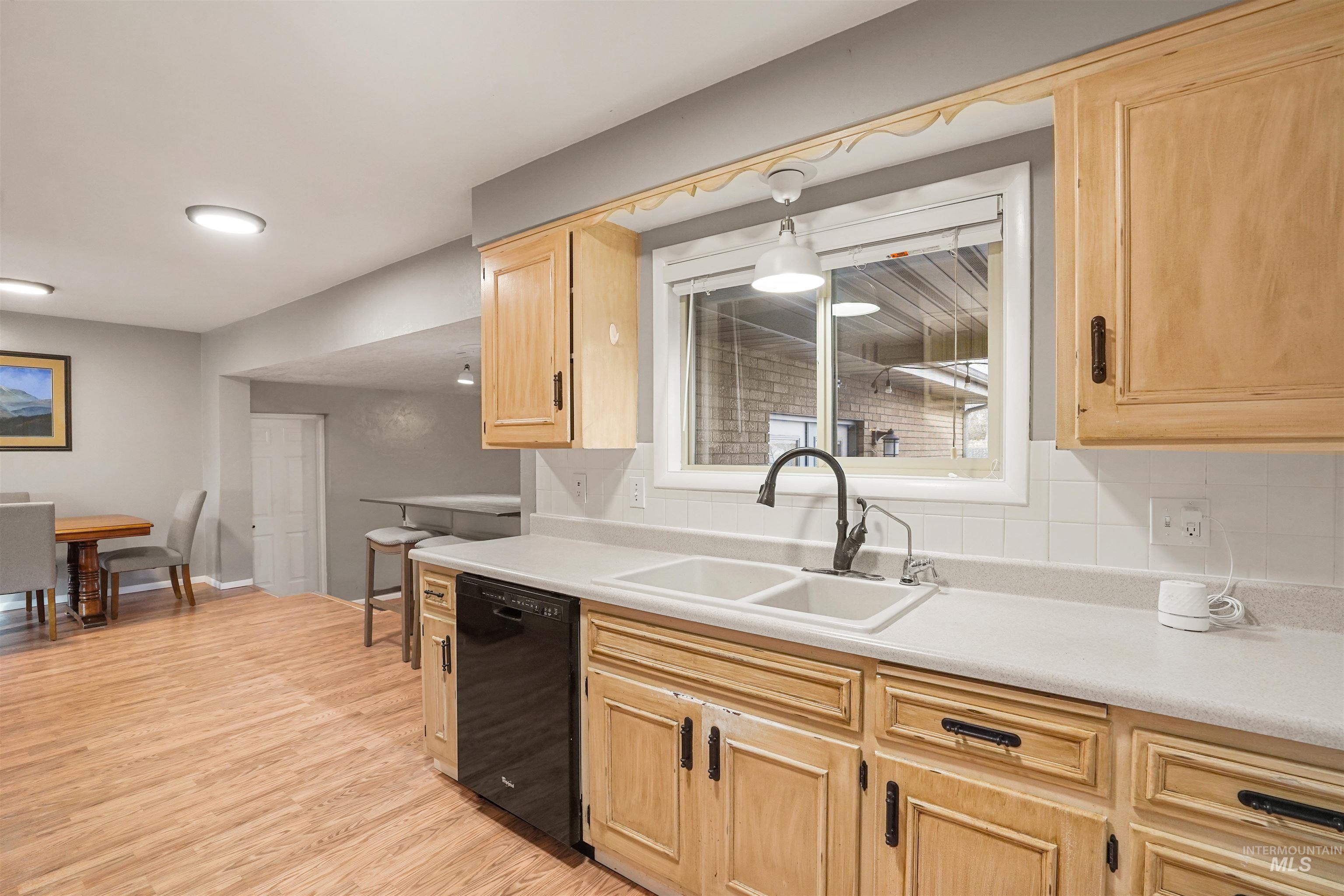 206 Pleasant Way Rupert, ID 83350 - Photo 6 of 33 Kitchen with light wood finish cabinets, dishwasher, light countertops, and light wood-type flooring