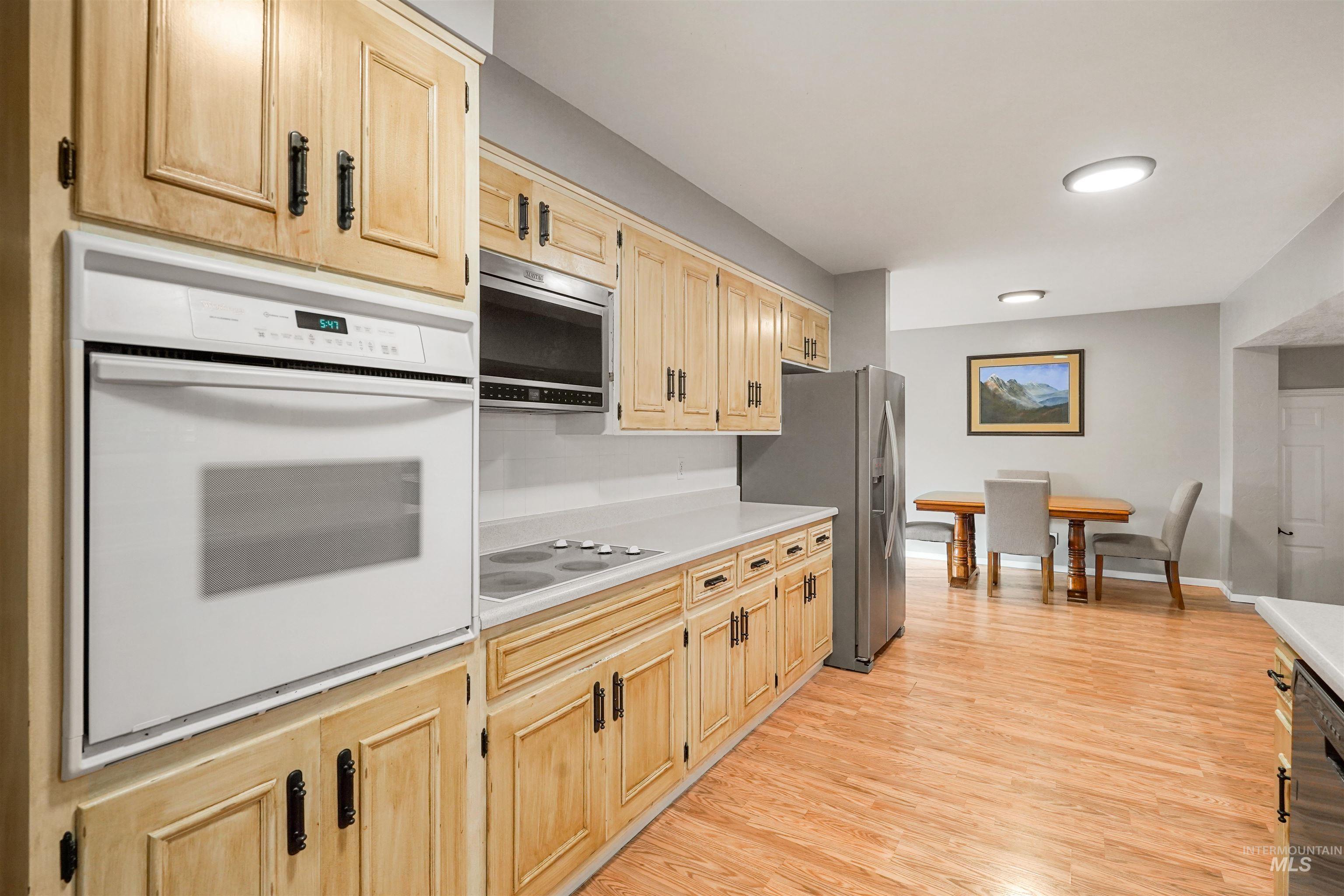 206 Pleasant Way Rupert, ID 83350 - Photo 8 of 33 Kitchen featuring stainless steel appliances, light countertops, light wood finished floors, and light wood finish cabinets