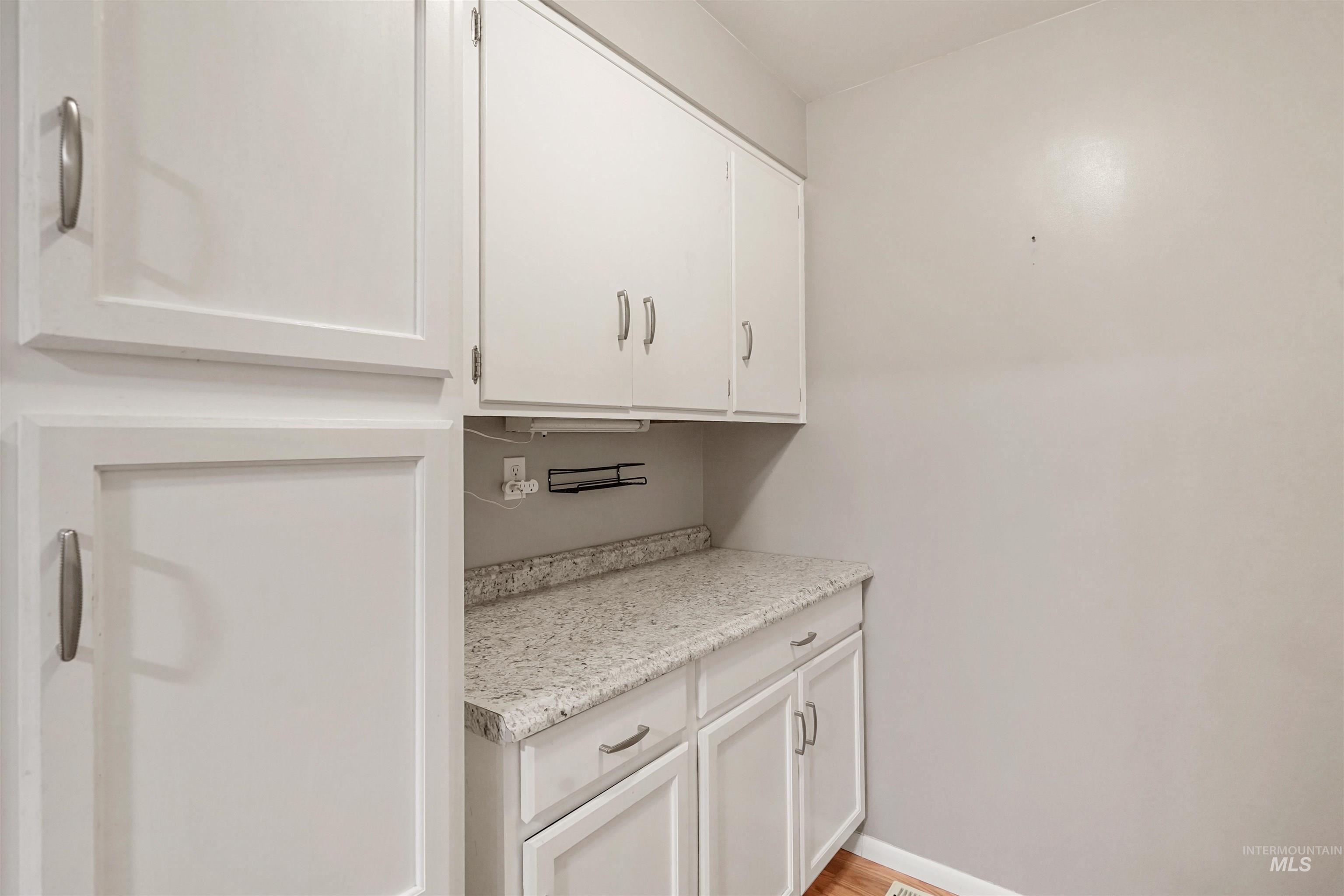 206 Pleasant Way Rupert, ID 83350 - Photo 10 of 33 Bar featuring light countertops, white cabinetry, and light wood-style floors