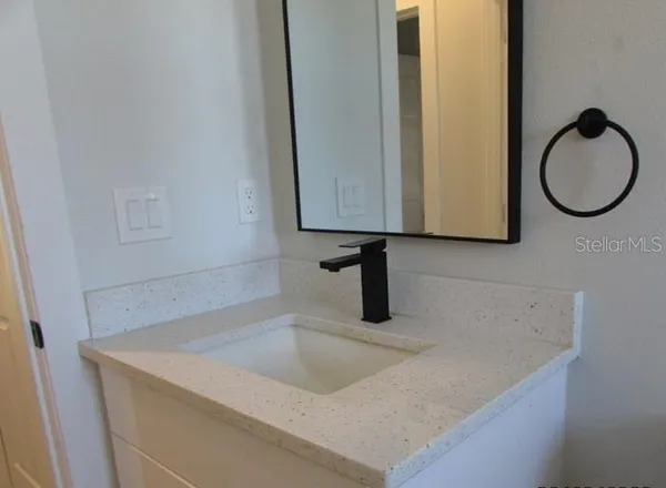 a bathroom with a sink and a mirror