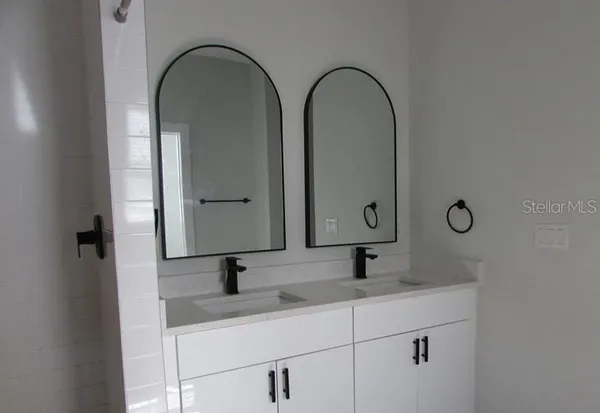 a bathroom with 2 sink and mirror