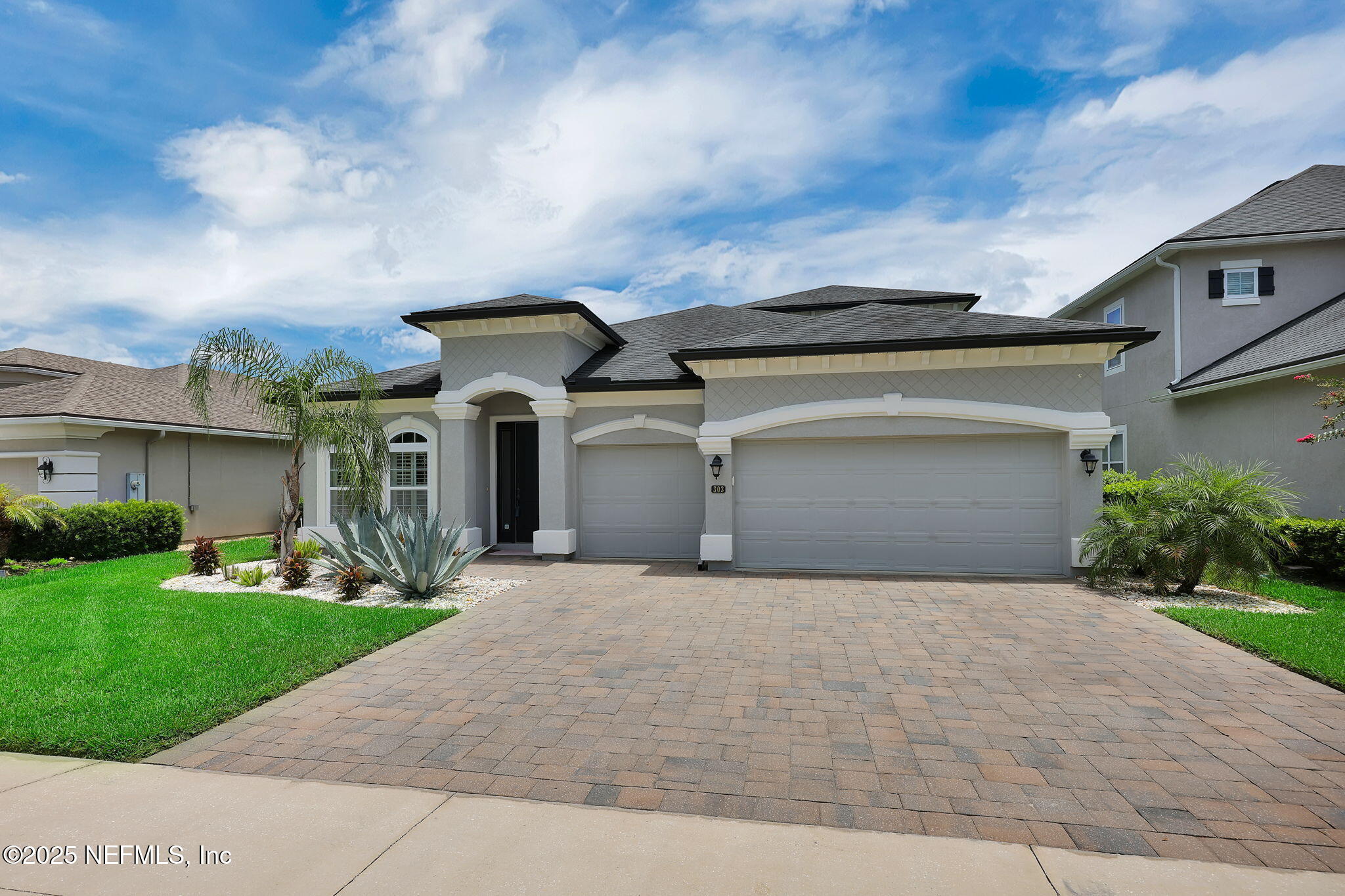 303 Gulfstream Way Ponte Vedra, FL 32081 - Photo 19 of 120 a front view of a house with a yard and garage