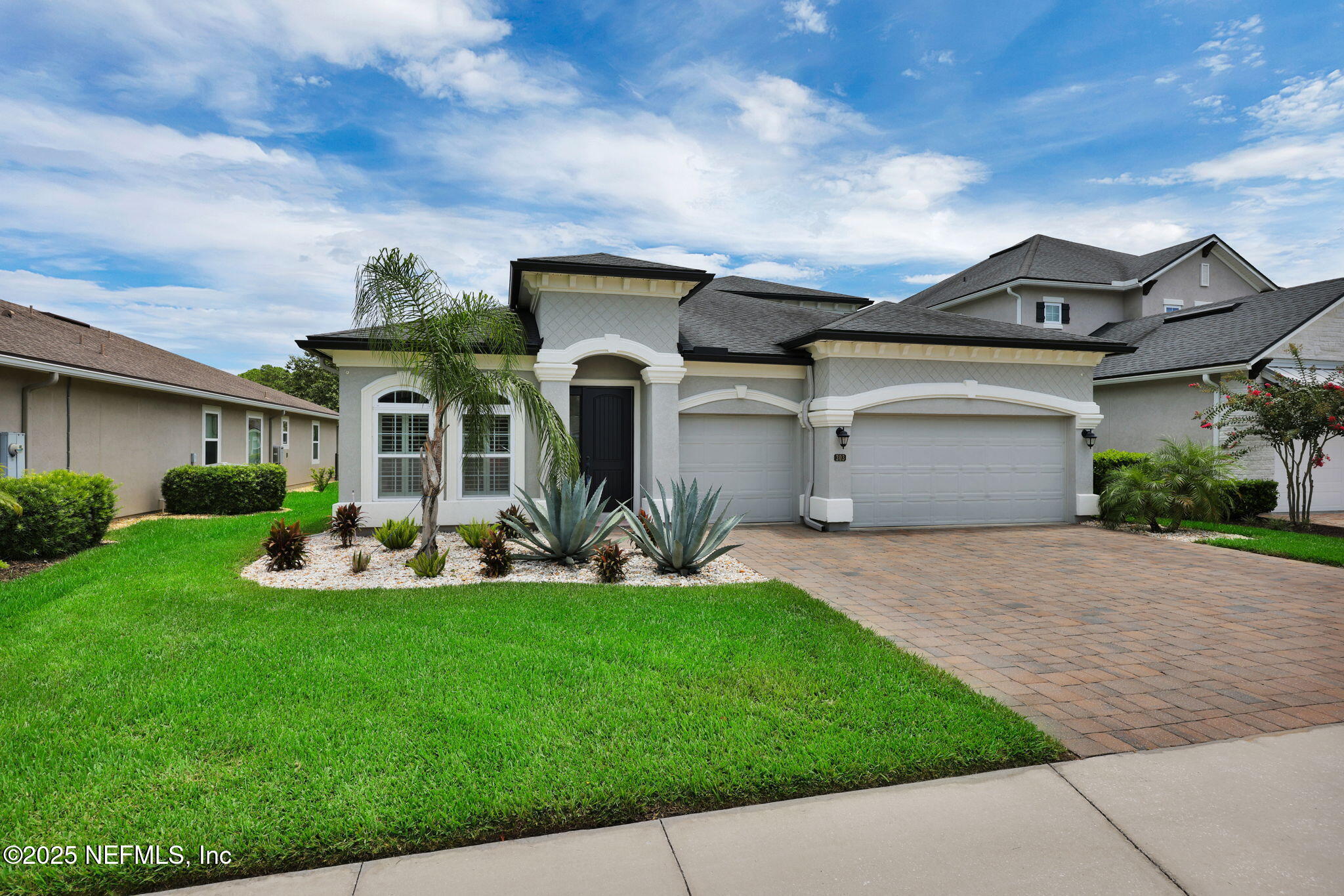 303 Gulfstream Way Ponte Vedra, FL 32081 - Photo 20 of 120 a front view of a house with a yard and garage