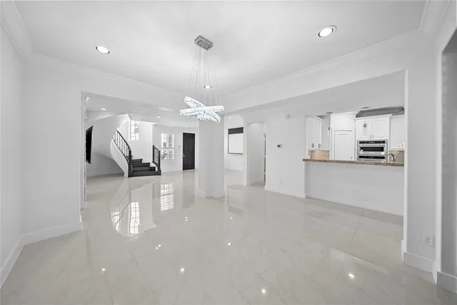 a view of a kitchen with refrigerator and windows