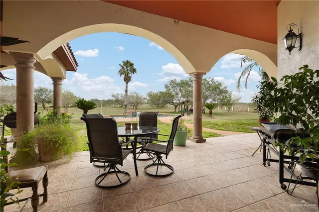 a view of a swimming pool and chairs in patio