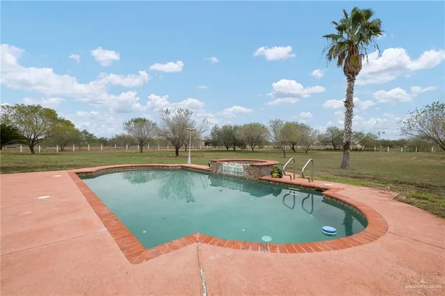 a view of a swimming pool and trees in the background