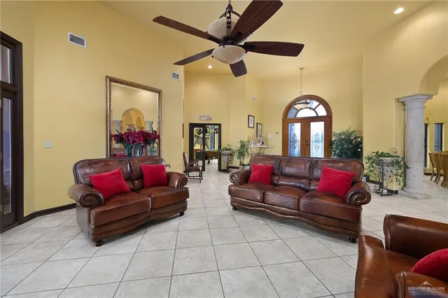 a living room with furniture and a mirror