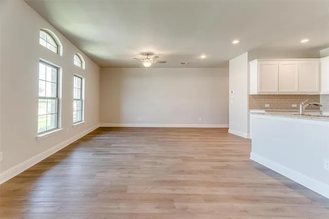 a view of a kitchen with a sink and a window