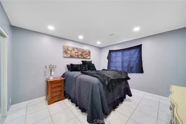 a spacious bedroom with a bed and a table