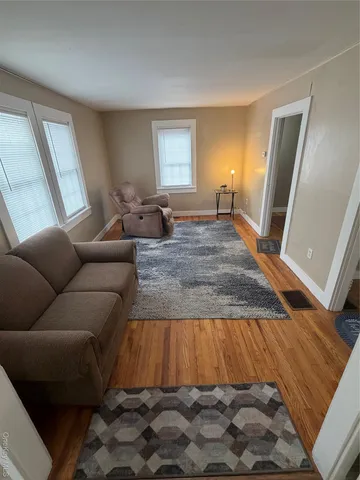 a living room with a couch and a window
