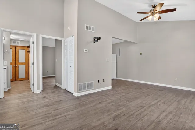 a view of empty room with wooden floor