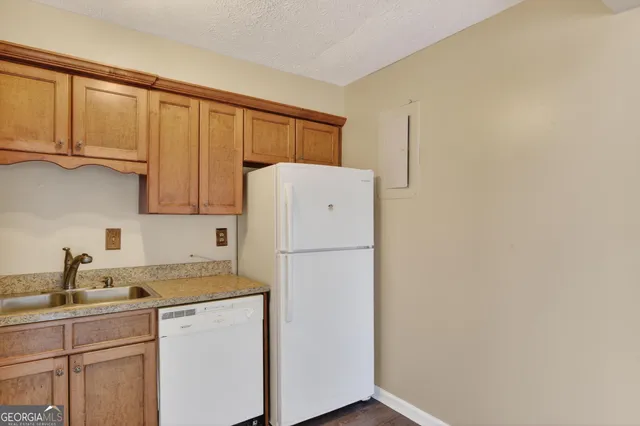 a white refrigerator freezer sitting in a kitchen