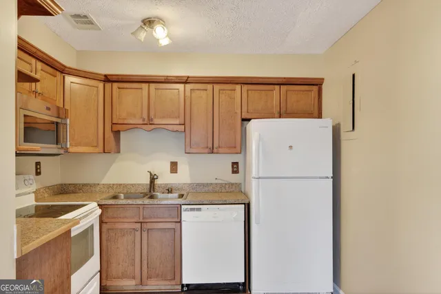 a white refrigerator freezer sitting in a kitchen