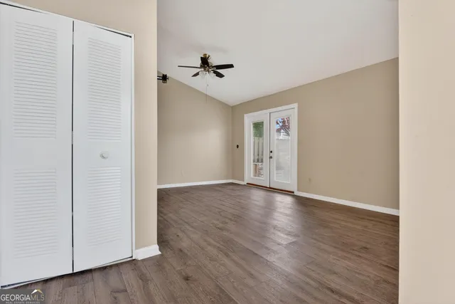 a view of empty room with wooden floor