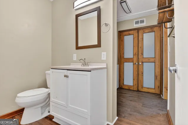 a bathroom with a toilet sink and a mirror
