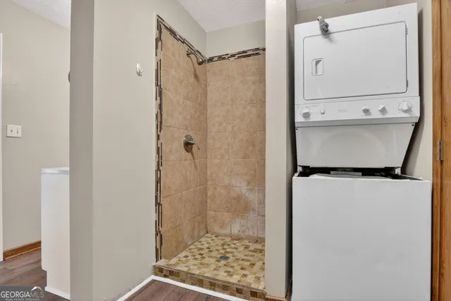 a bathroom with a shower and a mirror