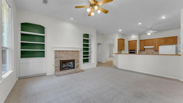 a view of a room with kitchen and fireplace