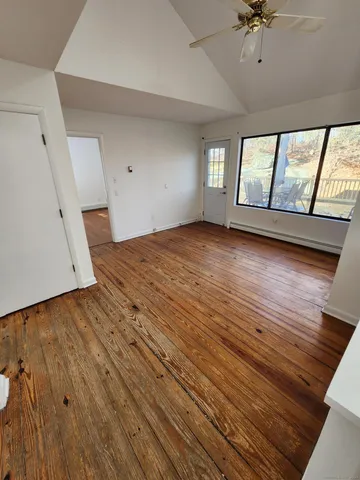 wooden floor in an empty room with a window