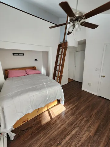 a bed sitting in a bedroom next to a window
