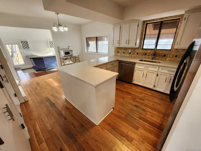 a kitchen with a stove a sink and a refrigerator