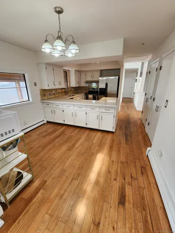 a view of kitchen with sink and wooden floor