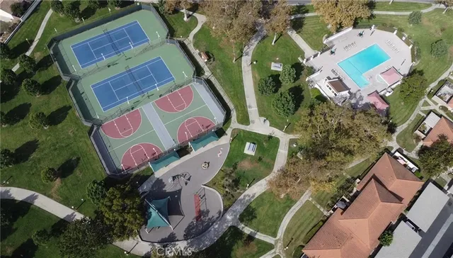 an aerial view of a house with a garden and parking space