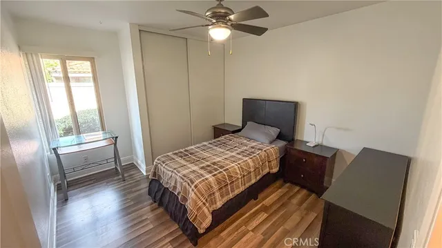 a bedroom with a bed and a lamp with window