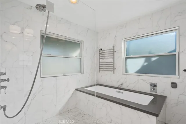 a bathroom with a tub sink and a mirror