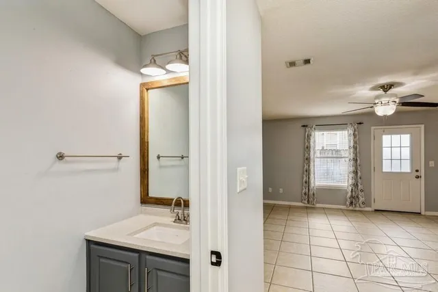 a bathroom with a sink vanity and a mirror