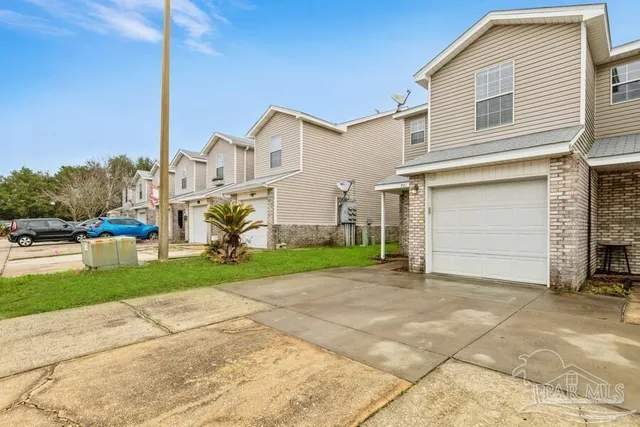 a view of a house with a backyard