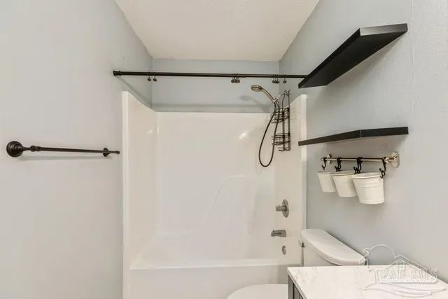 a bathroom with a shower toilet and sink