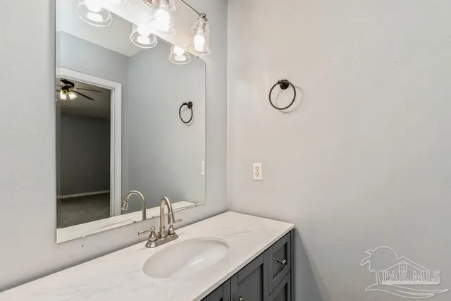 a bathroom with a sink vanity and a mirror