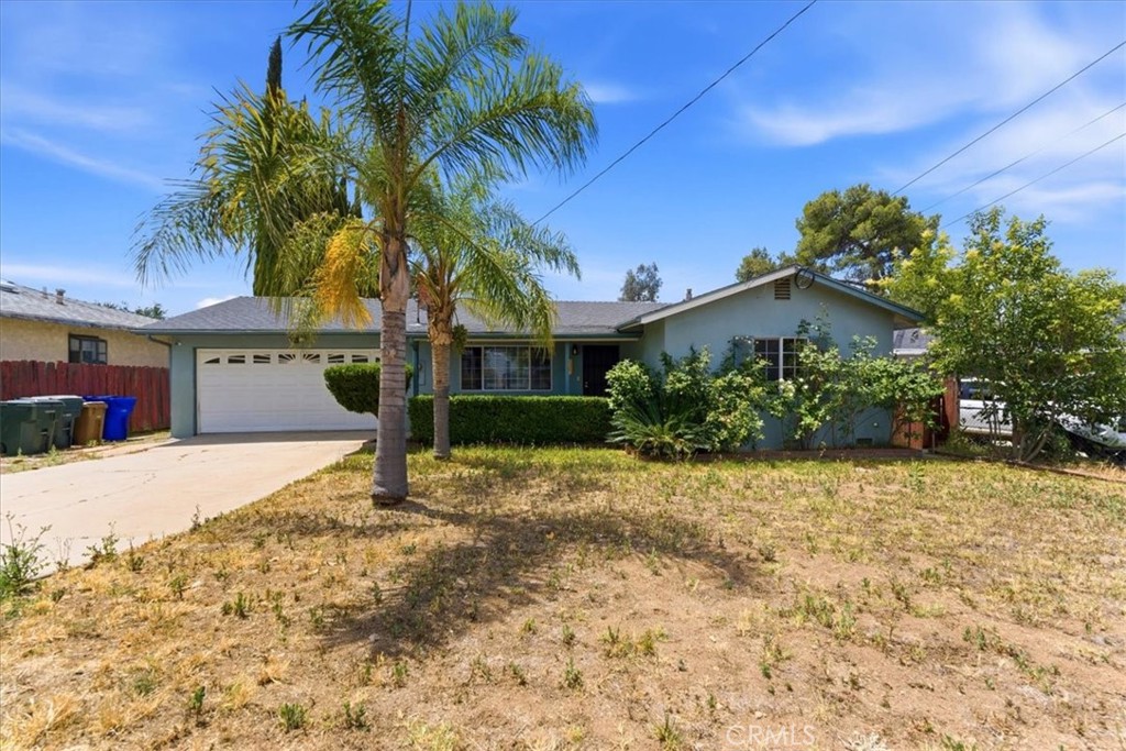 34863 Wildwood Canyon Road Yucaipa, CA 92399 - Photo 1 of 22 a house with a yard and parking space