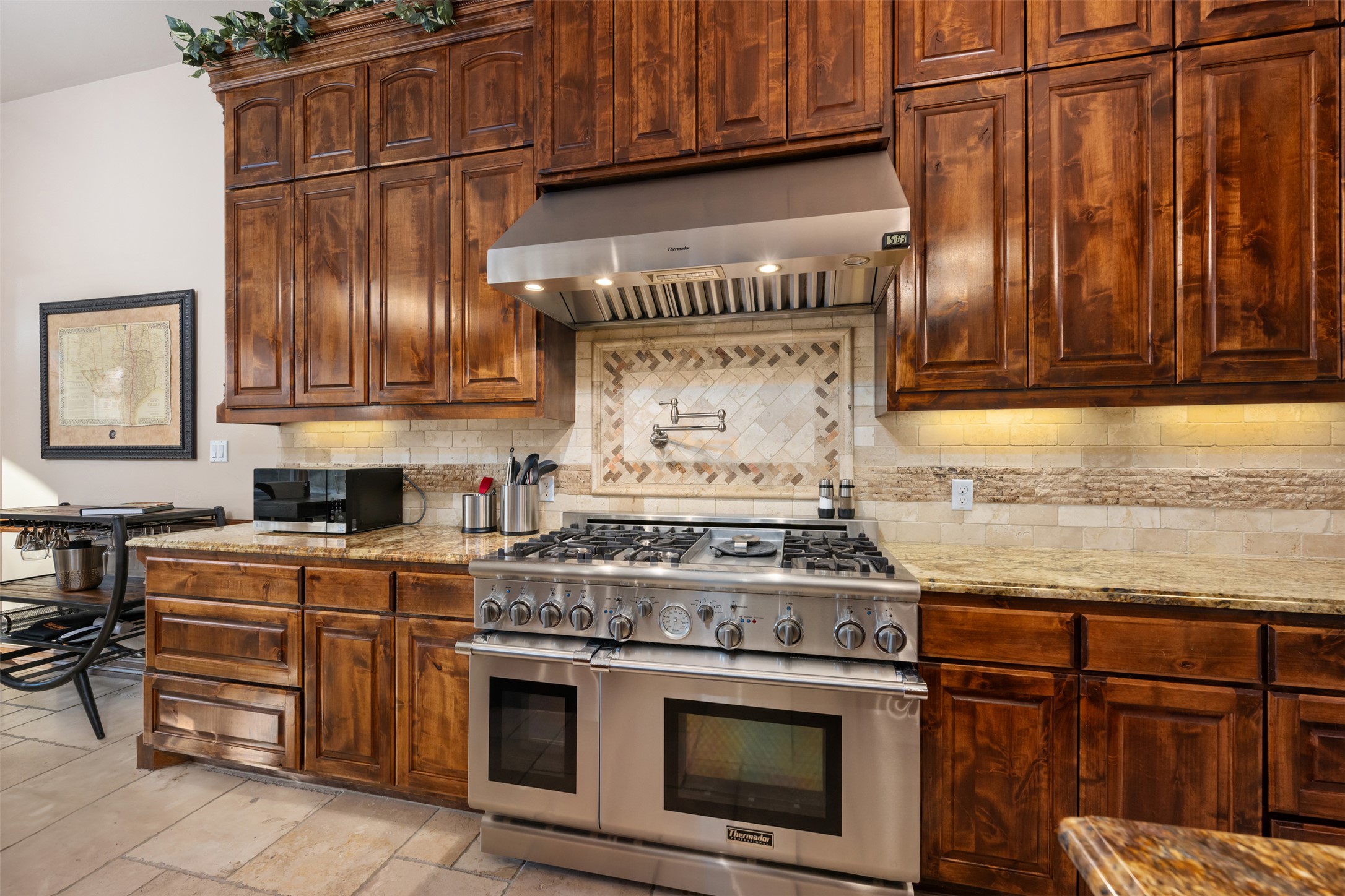 101 Hopewell Circle Georgetown, TX 78628 - Photo 11 of 38 Kitchen with double oven range, light stone counters, ventilation hood, and backsplash