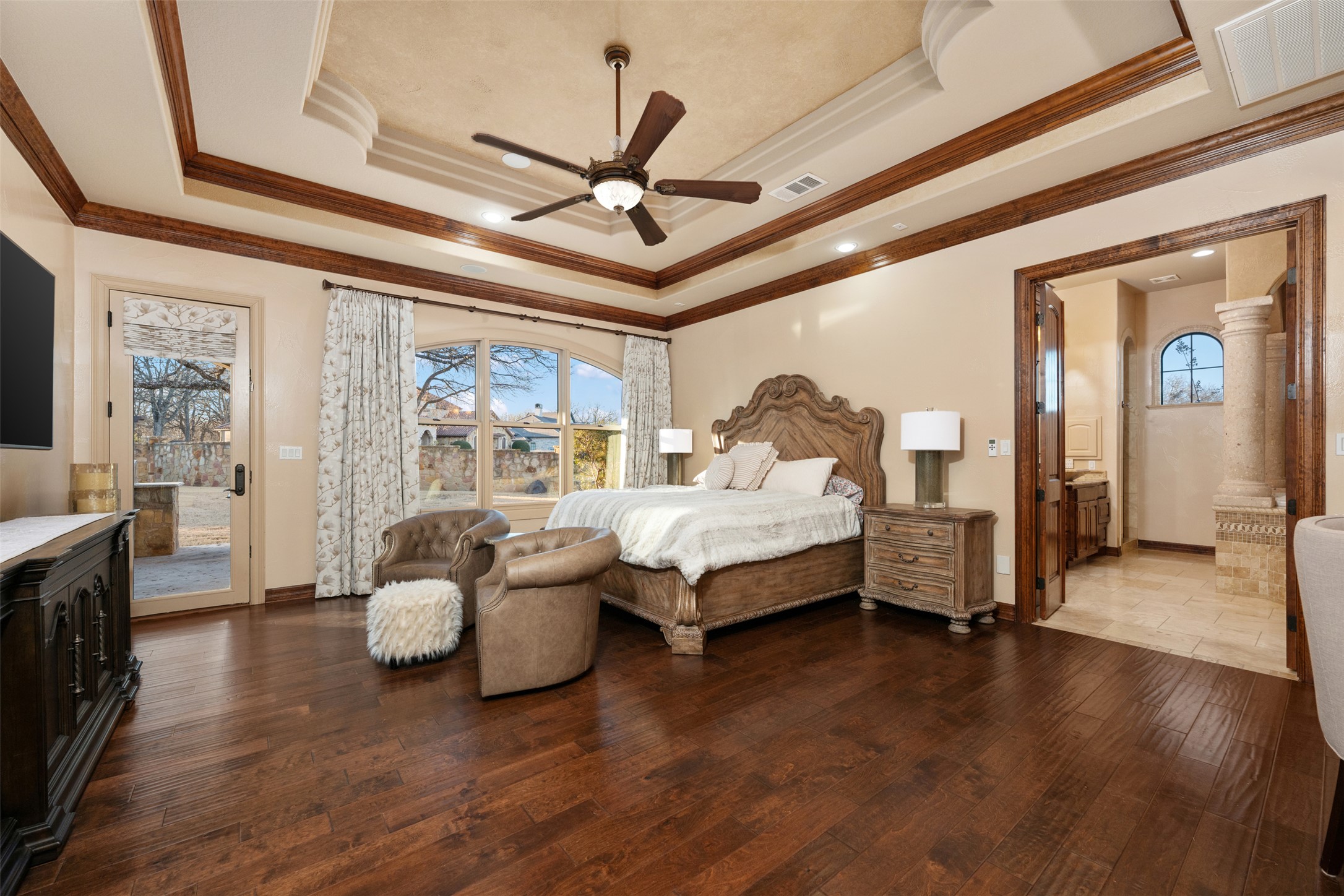 101 Hopewell Circle Georgetown, TX 78628 - Photo 13 of 38 Bedroom featuring dark wood-type flooring, access to outside, a ceiling fan, multiple windows, and crown molding