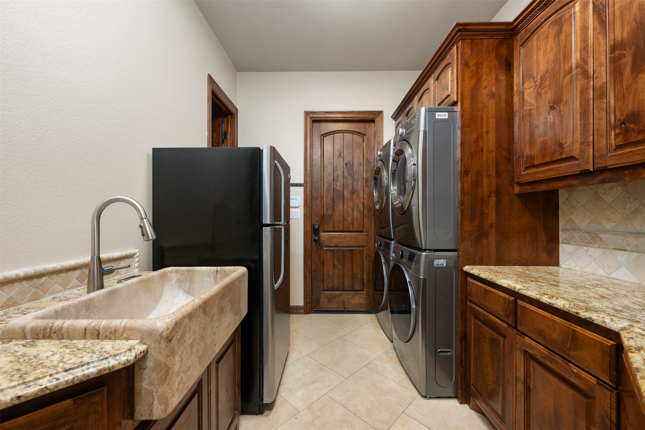 101 Hopewell Circle Georgetown, TX 78628 - Photo 18 of 38 Laundry room with stacked washer / drying machine and light tile patterned floors