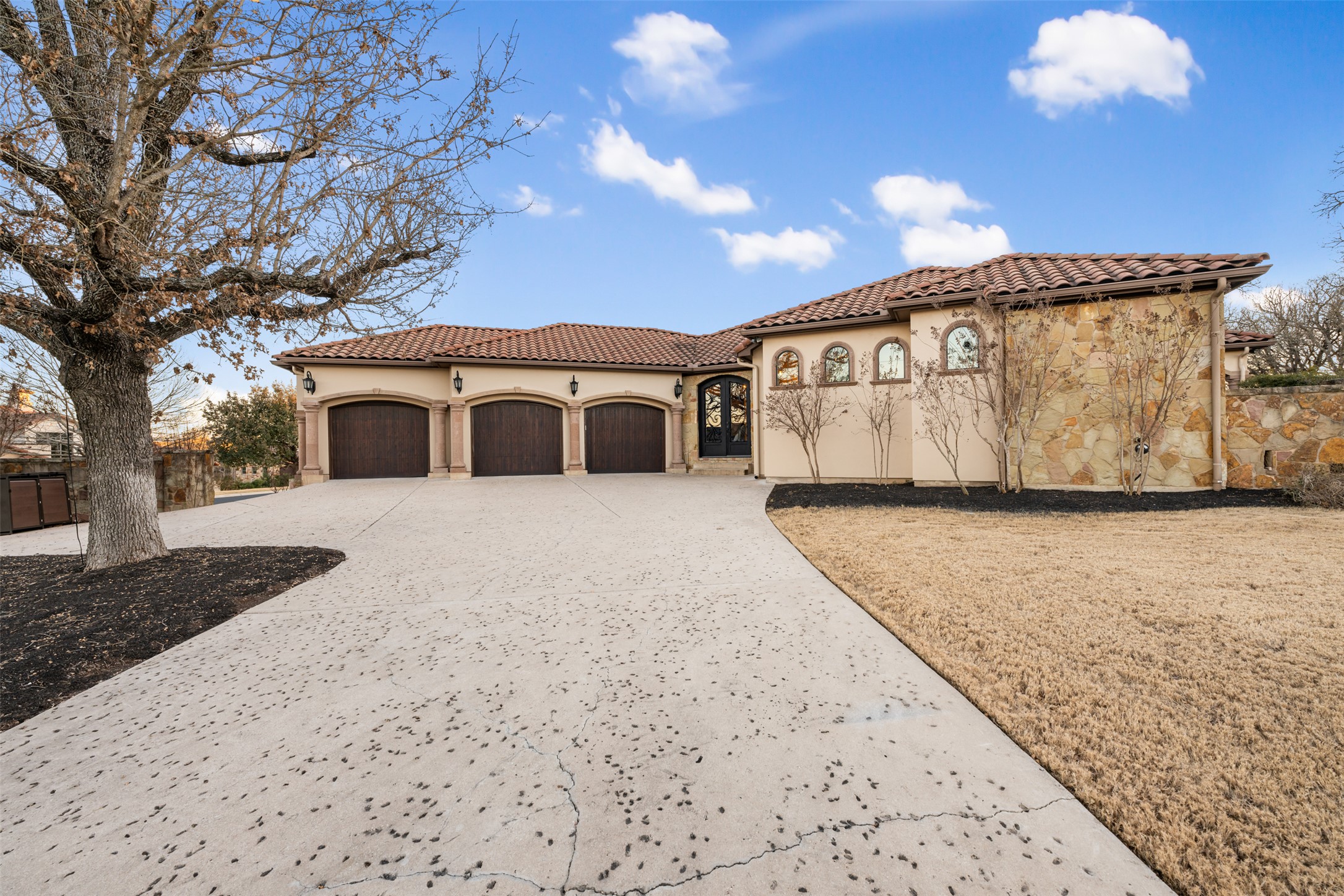 101 Hopewell Circle Georgetown, TX 78628 - Photo 2 of 38 Mediterranean / spanish home featuring stucco siding, a tile roof, concrete driveway, and an attached garage