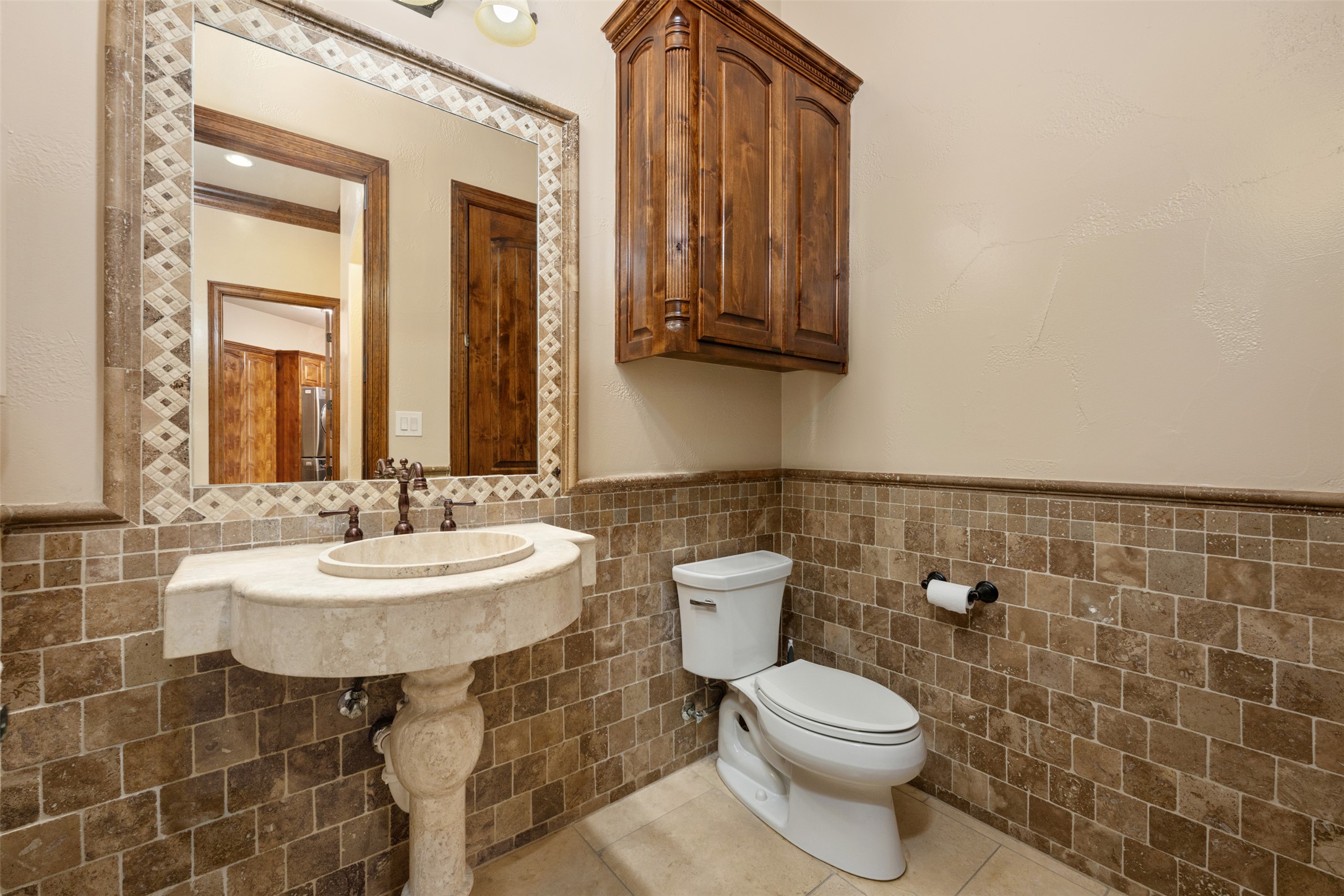 101 Hopewell Circle Georgetown, TX 78628 - Photo 26 of 38 Half bathroom featuring a wainscoted wall, tile walls, and tile patterned flooring